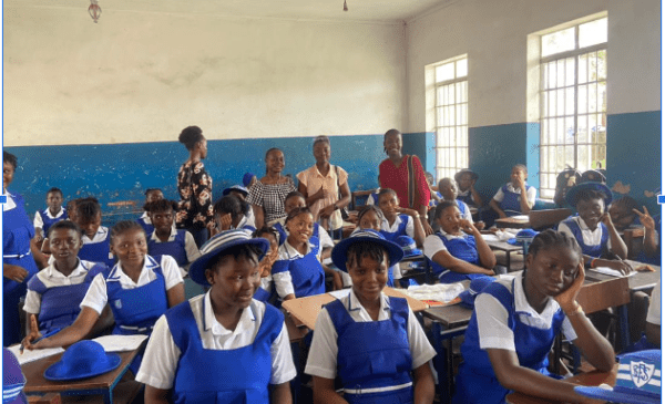 school girls in class wearing blue uniforms